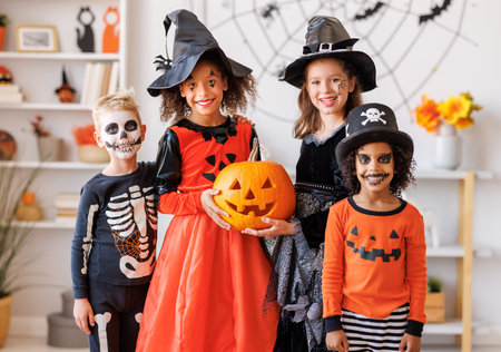 Happy Halloween. Kids in carnival costumes and makeup at homeの写真素材