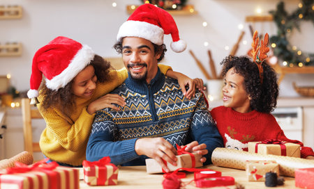 Happy african american family father and kids daughter and son pack Christmas giftsの写真素材