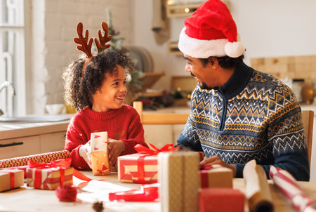 Happy african american family father and kid son pack Christmas giftsの写真素材