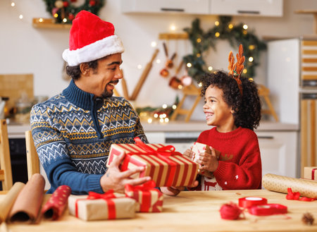 Happy african american family father and kid son pack Christmas giftsの写真素材
