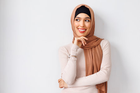 portrait of beautiful young smiling muslim woman in traditional religious hijabの写真素材