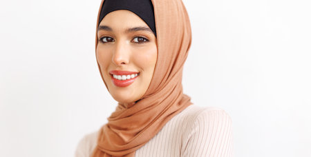 portrait of beautiful young smiling muslim woman in traditional religious hijabの写真素材