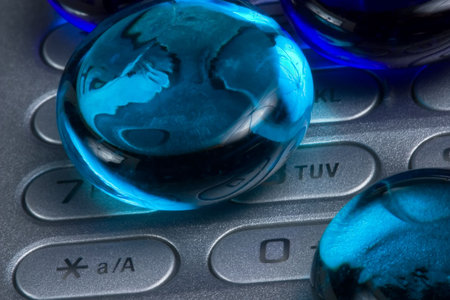 Closeup of glass balls on cellphone keyboardの写真素材