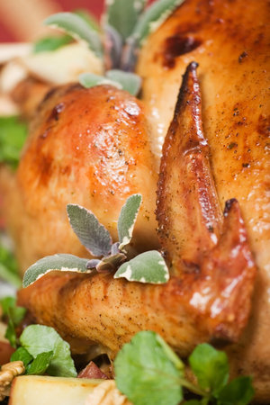 Christmas turkey served with herbs, baked potatos and walnuts on holliday tableの写真素材