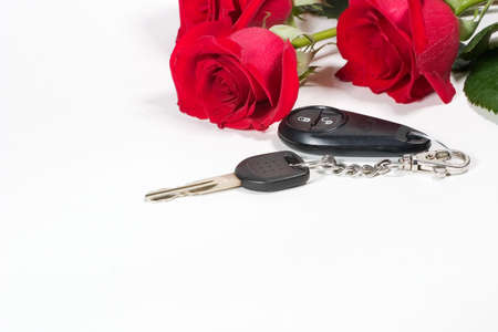 Beatiful scarlet roses bouquet and car keys as a Valentine day giftの写真素材