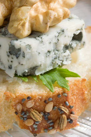 Closeup of blue cheese, walnut and arugula canape ready to eatの写真素材