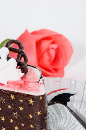 Closeup of delicious raspberry souffle cake with pink rose for your valentine with copyspaceの写真素材