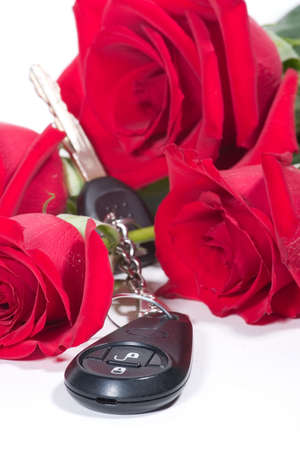 Beautiful scarlet roses bouquet and car keys as a Valentine day giftの写真素材