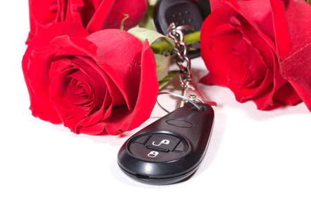 Beautiful scarlet roses bouquet and car keys as a Valentine day giftの写真素材