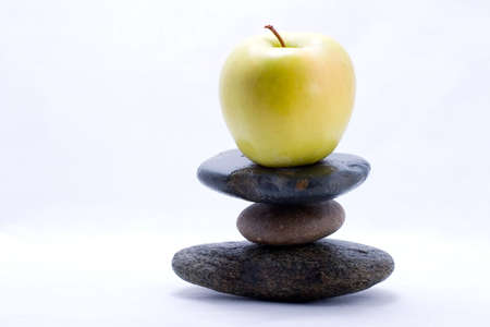 Apple on the top of zen stones pyramid in balanceの写真素材