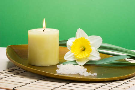 Aroma therapy with candle and spring daffodil flower, suited for spa and healthy lifestyle usage.の写真素材