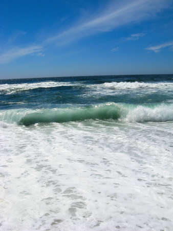 Blue sky seascape coastline with few clouds on itの写真素材