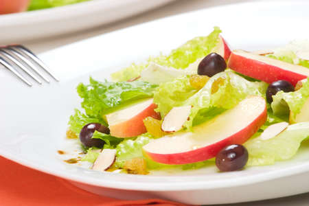 Fall salad with apples, almonds, raisins  and black olives served for healthy lunchの写真素材