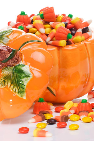 Orange pumkin filled with delicious  candyの写真素材