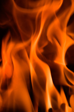 Flames in a fireplace in anybody house at cold weather