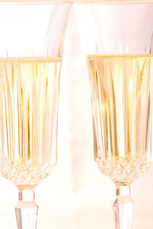 Closeup of two glasses of Champagne over holiday toned painted background out of focusの写真素材