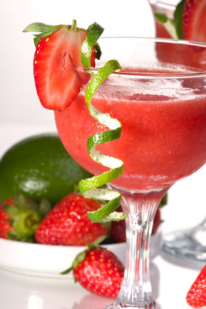 Strawberry Daiquiri cocktails. Rum, strawberries, liqueur, lime juice garnished with strawberry and twist of lime. Fresh strawberries and lime around. Most popular cocktails series.の写真素材