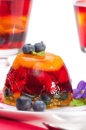 Closeup of delicious multi - layered fruit jelly made from wild strawberries, blueberries and slice...
