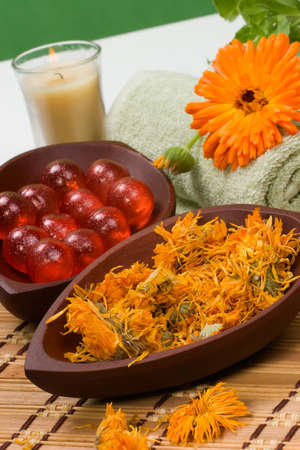 Fresh marigold spa set with fresh and dried flowers, aromatic oil balls, towels and arome candles. Best suited for relaxing and health commercialsの写真素材