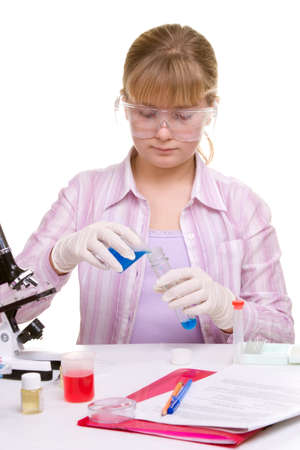 Student performing chemistry experiments with different liquids. Young adults education theme. の写真素材