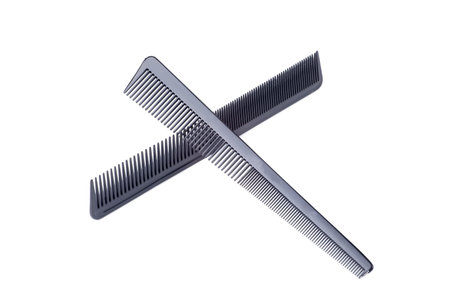 Closeup of two black barber combs on white