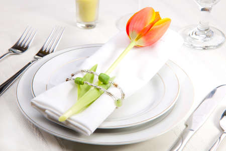 Fine food and wine spring table settings with fresh tulipsの写真素材