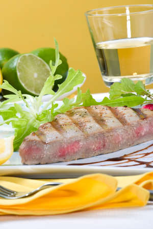 Juicy delicious Citrus-peppercorn-spiked grilled tuna steak with grilled vegetablesの写真素材