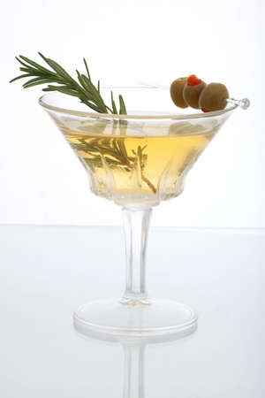 Glass of Rosemary Martini - gin, vodka, garnished with fresh rosemary sprig and olivesの写真素材