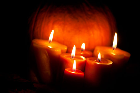 Closeup of festive aromatic candles burning merrily - fall themeの写真素材