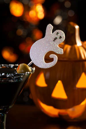 Closeup of Scary Martini, black vodka, vermouth, garnished with olive - Halloween drinks seriesの写真素材