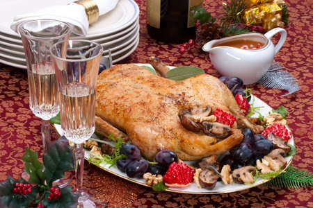 Garnished roasted duck on Christmas decorated tableの写真素材
