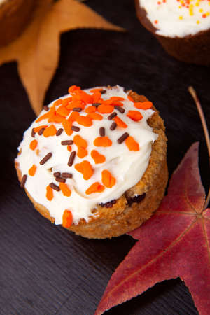 Full plate of just baked whole grain home made muffins in fall environment.の写真素材