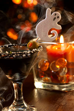 Closeup of Scary Martini, black vodka, vermouth, garnished with olive - Halloween drinks seriesの写真素材
