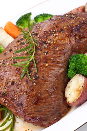 Roasted beef loin tri-tip, garnished with vegetablesの写真素材