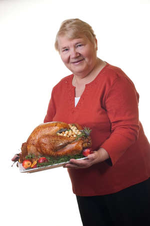 Garnished roasted turkey on platter is ready to be servedの写真素材