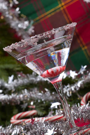Closeup of glass of Candy Cane Martini and Christmas ornamentsの写真素材