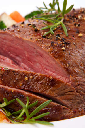 Roasted beef loin tri-tip, garnished with vegetablesの写真素材