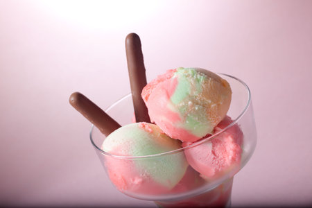 Closeup of delicious Fruit Sherbet icecream - lime, raspberry and orange with chocolate cookie.