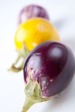 Fresh multi colored mini eggplants in rowの写真素材