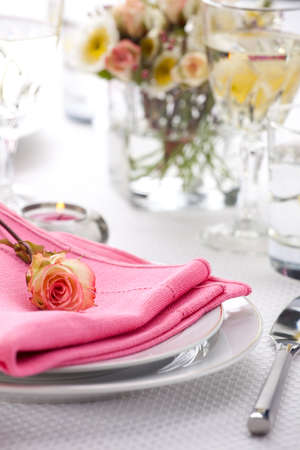 Romantic table settings. Arrangments with fresh roses and scented candlesの写真素材