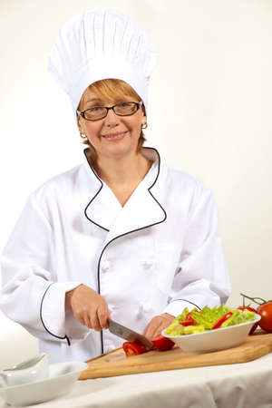 Executive chef preparing fresh organic salad, pouring dressingの写真素材