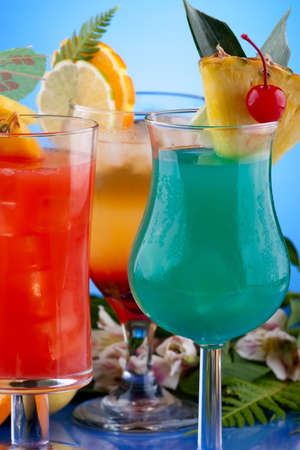Mai Tai, Blue Hawaiian and Hurricane cocktails surrounded by tropical fruits. Most popular cocktails series.の写真素材