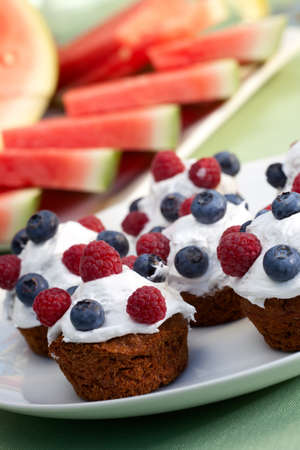 Muffins, fruits and cold drinks on picnic tableの写真素材