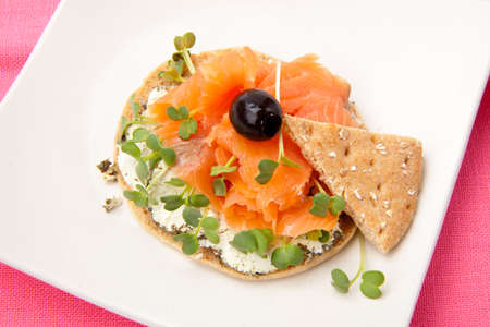 Closeup of delicious open-face sandwich with smoked salmon, goat cheese and daikon sprouts.の写真素材