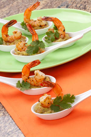 Spicy Shrimps and Guacamole with fresh cilantro a la carteの写真素材