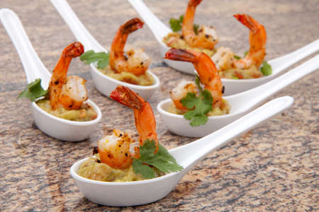 Spicy Shrimps and Guacamole with fresh cilantro a la carteの写真素材