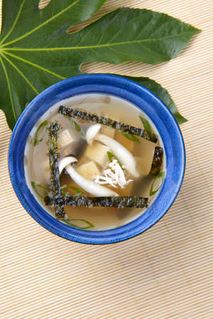 Closeup of bowl of miso soup with mushrooms, seaweeds and tofu.の写真素材