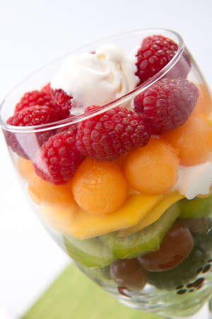 Serving of fresh rainbow fruit salad. Blackberries, red grapes, kiwi, mango, melon and raspberries.の写真素材