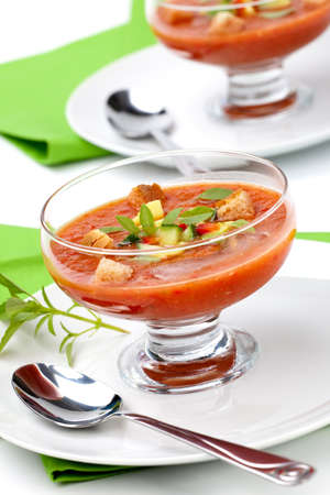 Two bowls of delicious cold Gazpacho soup with cucumber - avocado salsa. Good summer time appetizer.の写真素材