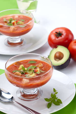 Two bowls of delicious cold Gazpacho soup with cucumber - avocado salsa. Good summer time appetizer.の写真素材